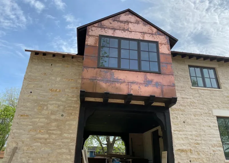 Copper metal panel facade on a stone building for Skylight Installation in Hooper