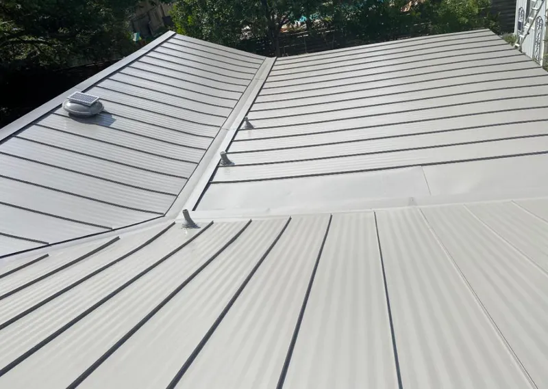 Solar attic fan installed on a metal roof for Roof Ventilation in Hooper